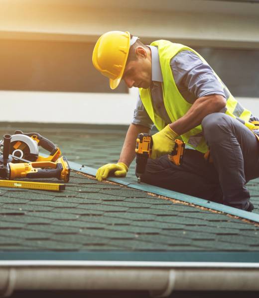 Roofer working in protective work wear gloves,